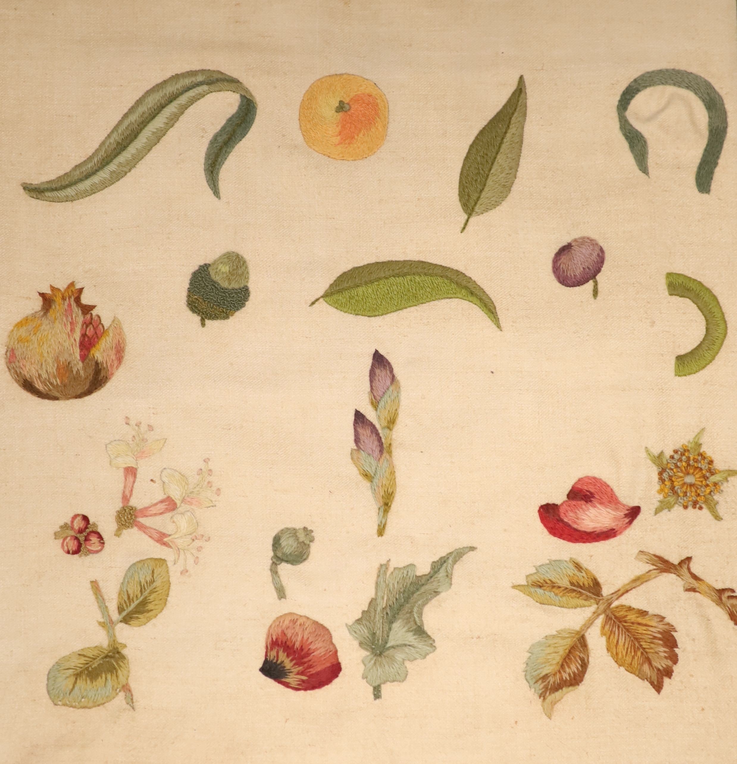 Two crewel work panels, one depicting fruits and flowers, the other quartered with foliage, 50 x 46cm, in simulated mahogany frames, overall 69 x 65cm